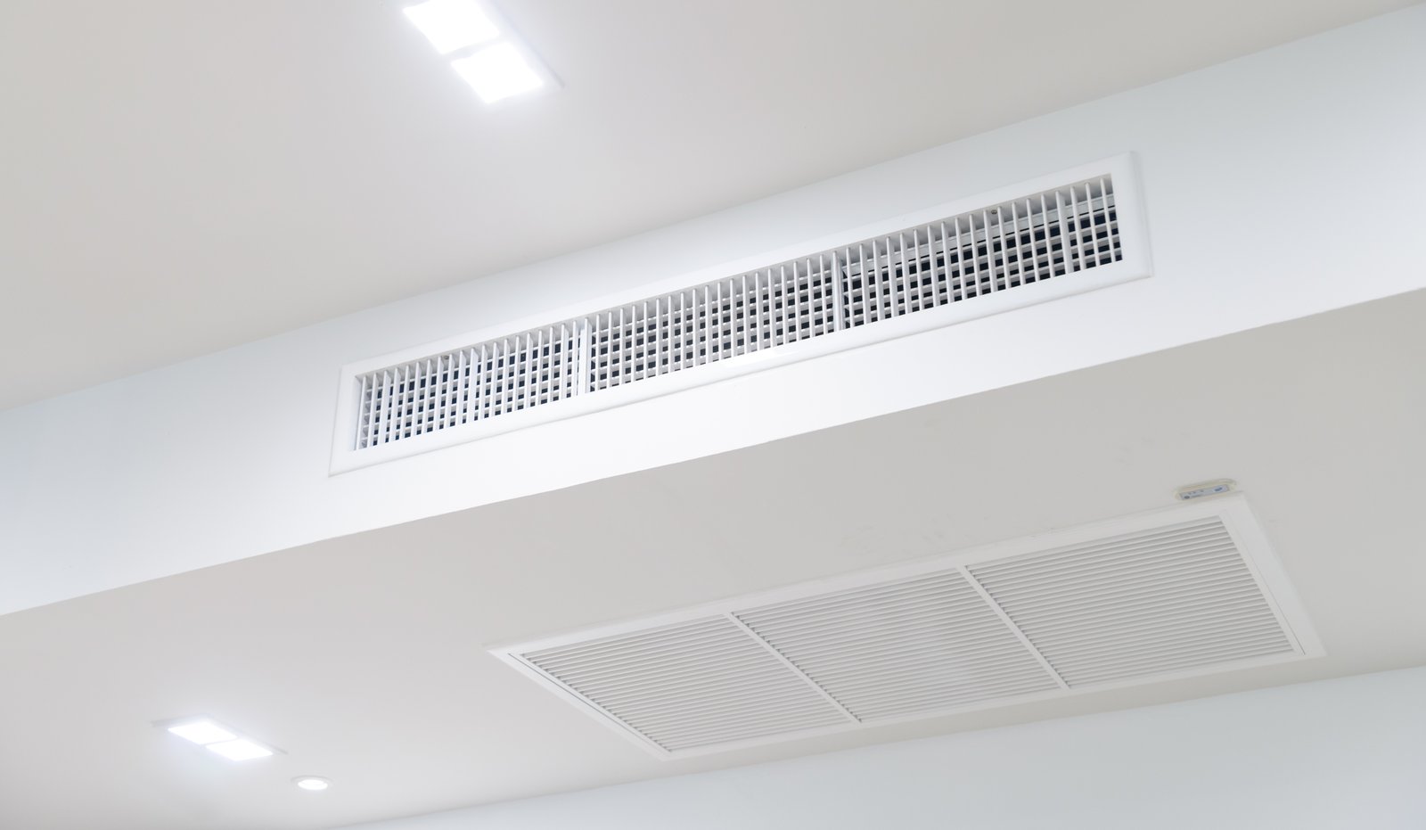 A modern ceiling-mounted HVAC air vent and return grille, designed for efficient airflow and ventilation in an indoor space.